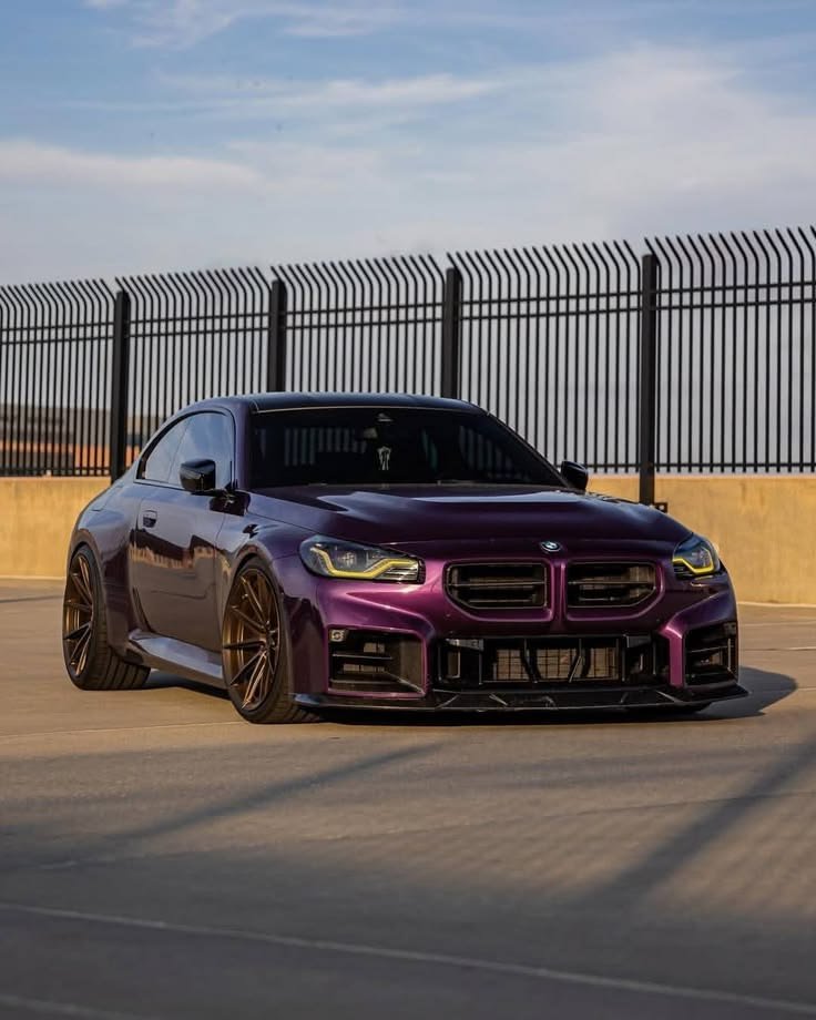 THE____SS's tweet photo. Deep metallic purple catching the midday sun, sitting aggressive on those bronze wheels. This thing breathes pure menace behind those yellow DRLs. 😈💜 https://t.co/BJpqGu32XQ