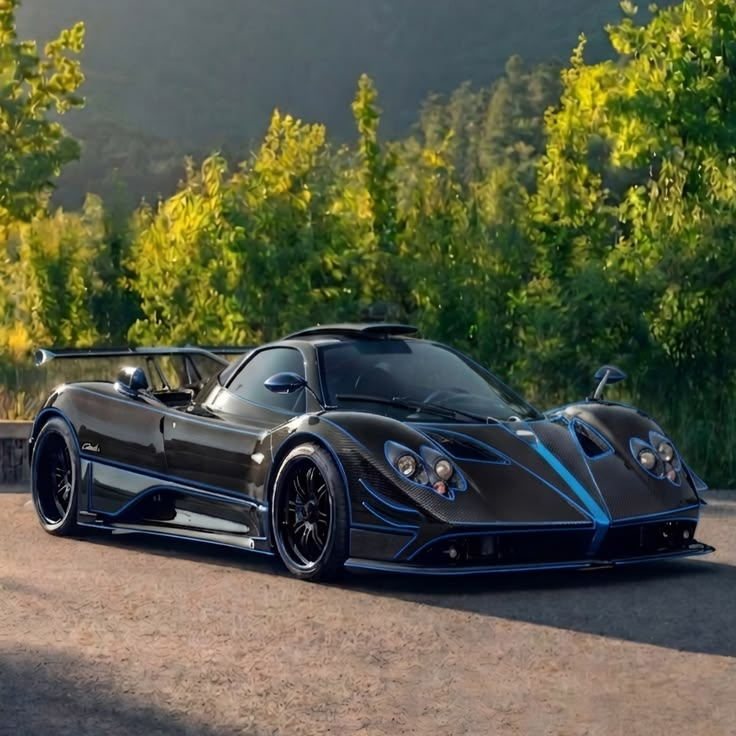THE____SS's tweet photo. Raw carbon and electric blue lines breathing against the green backdrop. This V12 art piece is waiting to shatter the silence of the canyons. 🖤⚡️ https://t.co/krIAEe9tYA