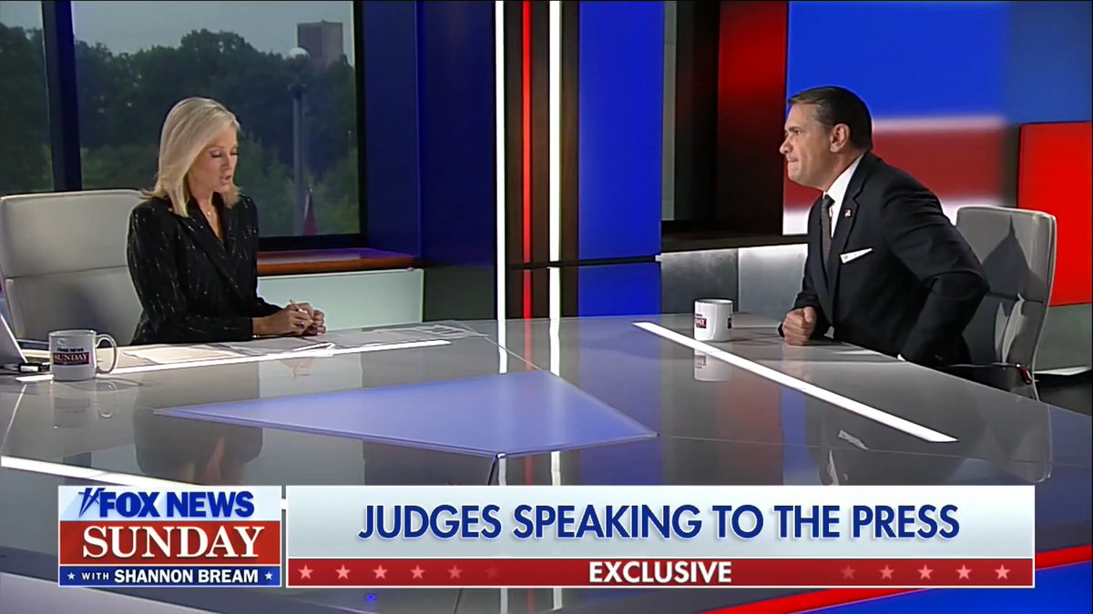 A screenshot from Fox News Sunday shows host Shannon Bream interviewing a guest across a glossy desk, with the on-screen banner reading "JUDGES SPEAKING TO THE PRESS - EXCLUSIVE." The image relates to the accompanying post about AG Todd Blanche discussing DOJ election monitors on the Sunday morning program.