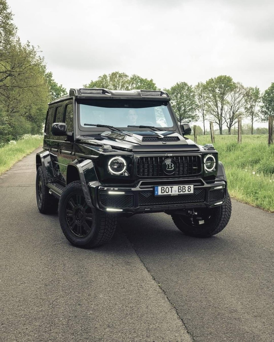 TaygraR's tweet photo. Pitch-black Brabus parked on the quiet country road, hiding a brutal V8 twin-turbo engine ready to conquer any terrain. Pure unstoppable force surrounded by nature. 🌲🖤 https://t.co/loH9JLCi8I