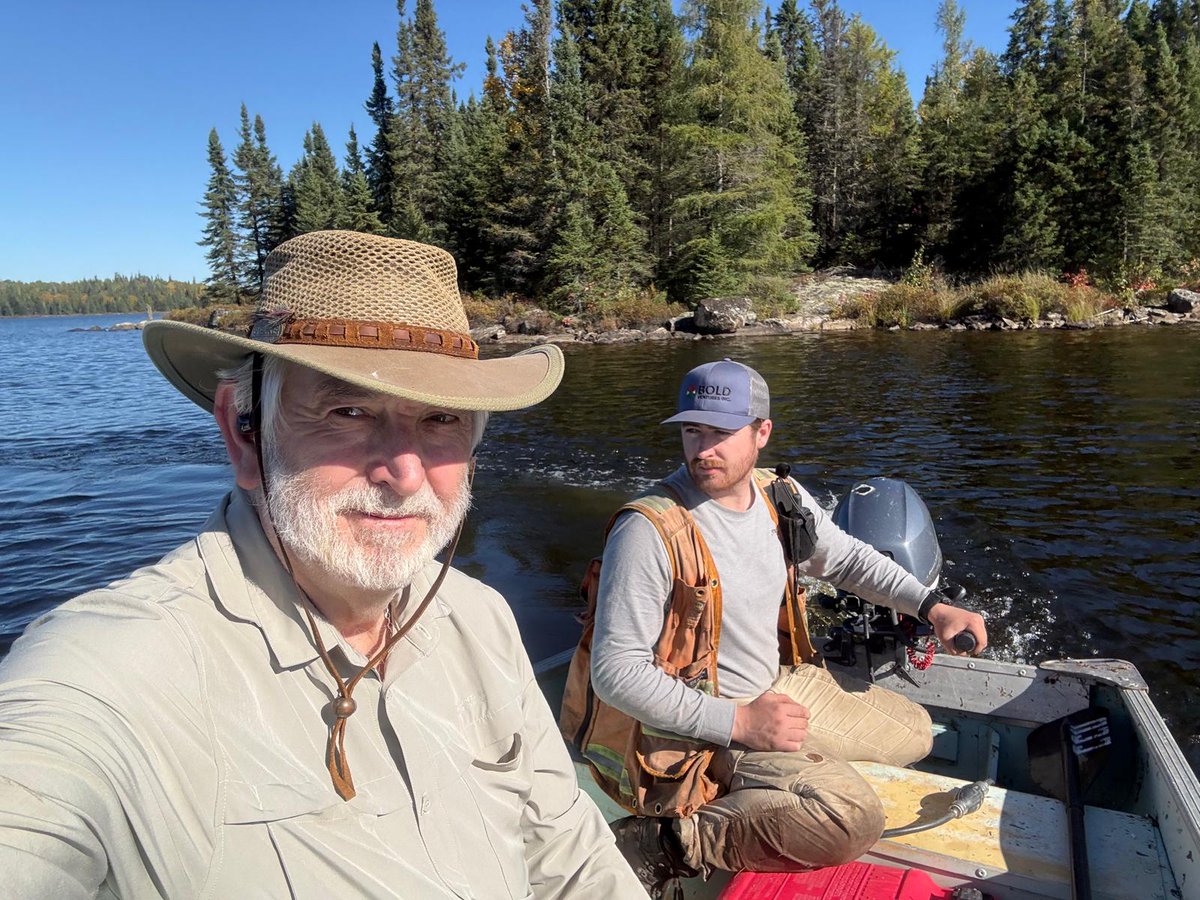 FirstClassMetal's tweet photo. CEO Marc Sale is out in the field with Brenden from EGS, heading into the Roy property for a closer look at the geology.
The side-by-side can only take them so far. From there, itโs a 10-minute trek through some fairly tough terrain to reach the moored boat - with Marc taking on the easy job of carrying the life jackets, while Brenden gets to manhandle the outboard! ๐
Once the boat is launched, itโs across the lake towards the outcrop. And what a day for it - crisp autumn air, spectacular colours and perfect conditions for exploring.
The journey is worth it.
At the outcrop, the team finds some very interesting material to collect for assay, providing another useful piece of the geological picture and a positive lift for the exploration programme ahead.
This is exploration in its most hands-on form - getting into the field, seeing the geology first-hand and building the understanding that shapes what comes next.
Watch the short video series to learn more: https://t.co/pZO1swvaVA
Explore. Explain. Expand. Enhance.
#FirstClassMetals #FCM #Roy #Ontario #Exploration #Geology #Mining #GoldExploration #Fieldwork