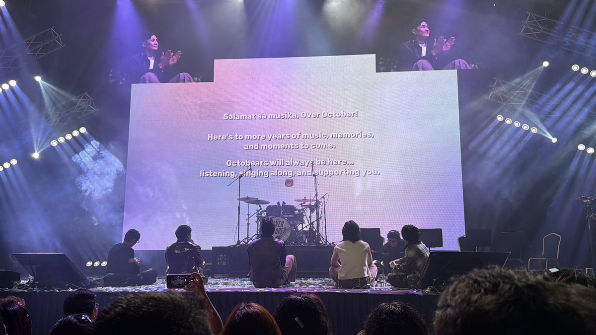 philconcerts's tweet photo. Over October marked 12 years of music with its biggest solo concert yet tonight at the New Frontier Theater, bringing the Octobears together for a night of songs, memories, and celebration. The milestone show traced the band’s journey across its catalog, revisiting music that has soundtracked different chapters of its story while looking ahead to what comes next.

The anniversary celebration also brought Benny of The Ridleys, Ena Mori, Angela Ken, and Apo Hiking Society’s Jim Paredes and Boboy Garrovillo joining @overoctoberph onstage.

Running alongside the celebration was a bittersweet farewell. After 12 years behind the drums, Janessa performed her final concert with Over October, sharing the stage with Josh, Anton, Lua, and Joric for the last time as a five-piece. “Big thank you to you, boys, for 12 years. It’s not easy—leaving. Thank you for choosing me to be your drummer,” she told her bandmates, reflecting on the years they spent building the band together.

Janessa also turned her gratitude toward the Octobears, recognizing the community that has grown alongside Over October throughout its 12-year journey. “Literally, you made this. We are standing here because of you,” she told the crowd.

Over October closed the celebration with “Ikot” and “Kaakit-Akit,” giving the Octobears a final sing-along before the band took its last bow at the New Frontier Theater.