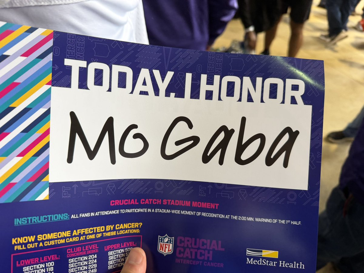 NextNetworkJosh's tweet photo. Ravens handing out Mo Gaba signs for the crucial catch tribute. We will never forget you Mo 💜 https://t.co/Y0Yqh7QJpl