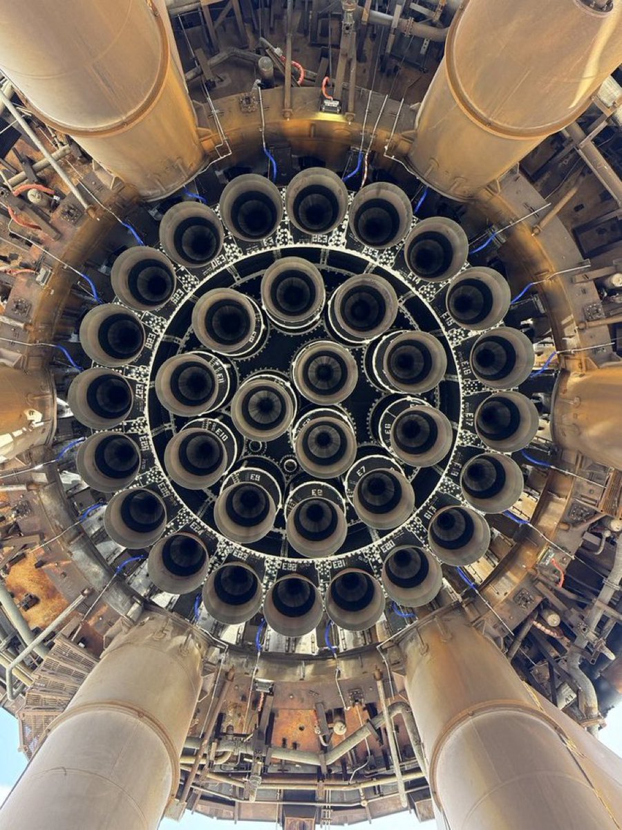 RobLogic's tweet photo. The business end of Super Heavy: 
33 Raptors arranged to lift the first Mars-bound Starship, which Musk has said will be called Heart of Gold https://t.co/Fa5uNOkPMZ