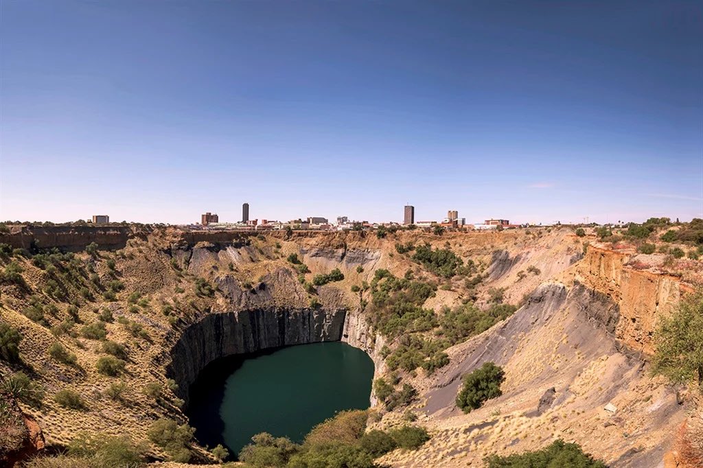 SabzerAzoh's tweet photo. Cecil John Rhodes was not merely a greedy businessman or an agent of the British Empire; he was a highly initiated esoteric operative who understood that, to colonise a continent permanently, you must first hijack its electromagnetic spinal cord. When I re-examine the Kimberley Big Hole, Rhodes’s burial at Matopo Hills, and his famous doctrine of “Cape to Cairo,” I step completely out of political history and into the raw mechanics of occult grid sabotage and Kundalini containment.

Before the colonial machine arrived, the site that is now the Kimberley Big Hole was a highly sacred geographic anomaly. It was a massive natural vortex, a volcanic pipe filled with Kimberlite rock, which acts as the deep-crust matrix that births diamonds.

The Diamond as an Energetic Transfocuser: In the cryptographic network of the Earth’s crust, diamonds are not fashion accessories. They are hyper-compressed carbon lattices that function as cosmic light amplifiers and frequency transmitters. Kimberley was the central energy valve, the heart plexus where the fiery solar codes of the Northern Cape’s Tiger’s Eye intersected with the deep-water memory lines of the interior.

Cecil John Rhodes, through the formation of De Beers, did not just dig for profit. He systematically hollowed out this sacred vortex, creating a literal wound in the planetary nervous system. By blasting open and removing millions of carats of crystalline amplifiers, Rhodes successfully punctured the local ley lines, interrupting the natural flow of the Earth’s spiritual currents. This deliberate disruption was executed to throw the region’s spiritual posture into a state of permanent chaos and submission.🍃🫶🏽