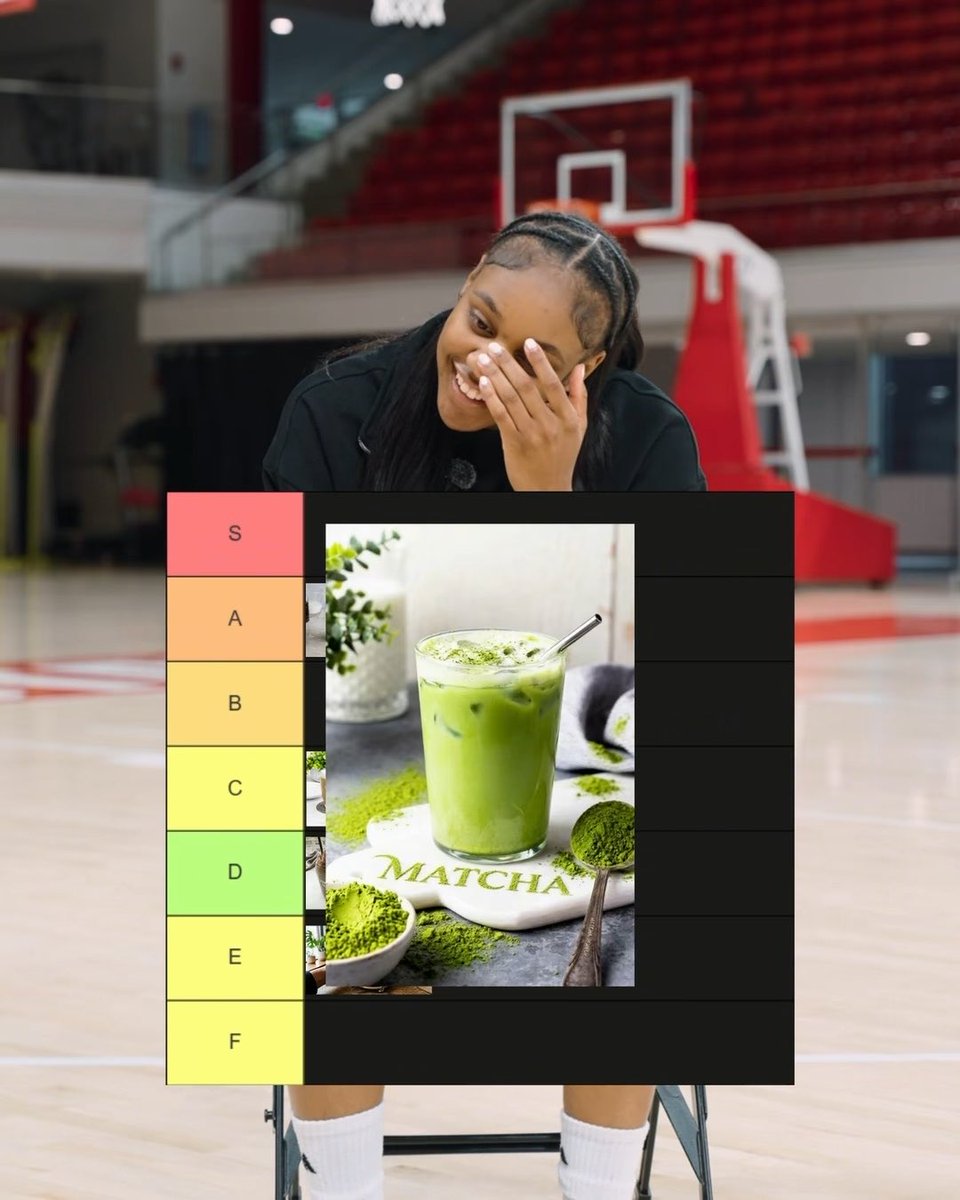 A woman laughing and covering her face on a basketball court, with a tier ranking chart overlaid showing a green matcha drink ranked between D and E tiers.