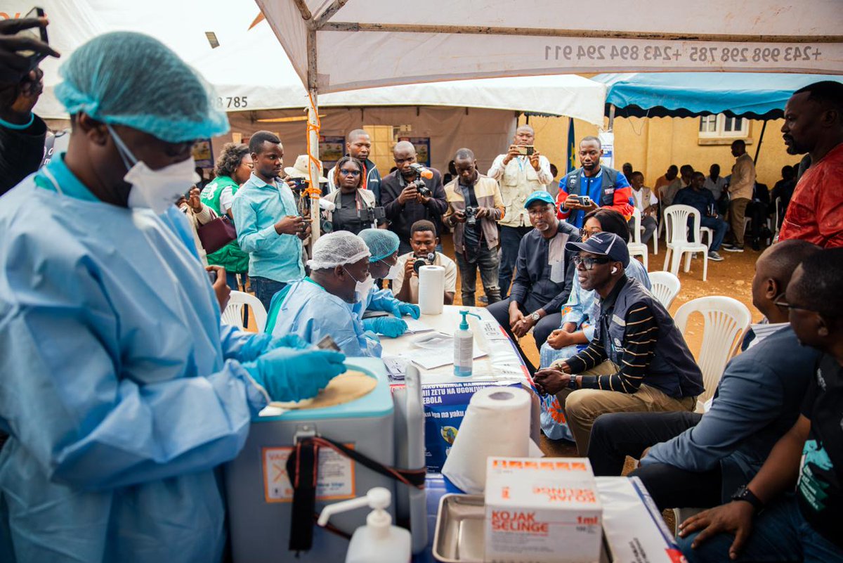 ProfJanabi's tweet photo. Yesterday in Beni, North Kivu, alongside Provincial Minister of Health Madam Prisca Luanda and National Incident Manager Professor Steve Ahuka, we launched ERVEBO vaccination under the compassionate-use framework.  

Starting with health workers and frontline responders, North Kivu joins the national effort launched in Kisangani on 27 August, with more than 9,000 frontline workers already vaccinated.  

ERVEBO is a safe vaccine that has saved many lives in previous Ebola outbreaks in DRC. While developed against Zaire ebolavirus and not Bundibugyo virus, laboratory data suggest it may offer some cross-protection. This was my fourth visit to eastern DRC since the outbreak began. 

I thank the Government of DRC for its leadership and guidance, and all partners working alongside WHO in this response. Outbreaks are defeated not only by vaccines, but by courage, solidarity and the dedication of frontline workers.   

Together, we protect lives. 
--------------------------------  

Hier à Beni, au Nord-Kivu, aux côtés de la Ministre Provinciale de la Santé, Mme Prisca Luanda, et du Gestionnaire National d'Incident, le Professeur Steve Ahuka, nous avons lancé la vaccination ERVEBO dans le cadre de son utilisation compassionnelle.  

En commençant par les agents de santé et les intervenants de première ligne, le Nord-Kivu rejoint l'effort national lancé à Kisangani le 27 août, avec déjà plus de 9 000 agents vaccinés.  

ERVEBO est un vaccin sûr qui a sauvé de nombreuses vies lors des précédentes flambées d'Ebola en RDC. Bien qu'il ait été développé contre l'Ebolavirus Zaïre et non contre le virus Bundibugyo, les données de laboratoire suggèrent une possible protection croisée. Il s'agissait de ma quatrième visite dans l'Est de la RDC depuis le début de la flambée.   

Je remercie le Gouvernement de la RDC pour son leadership et son orientation, ainsi que tous les partenaires qui travaillent aux côtés de l'OMS dans cette riposte.  Les épidémies ne sont pas vaincues par les vaccins seuls, mais aussi par le courage, la solidarité et l'engagement des personnels de première ligne. 

Ensemble, nous sauvons des vies.
-------------------------------  

Ontem, em Beni, no Kivu do Norte, juntamente com a Ministra Provincial da Saúde, Sra. Prisca Luanda, e o Gestor Nacional do Incidente, Professor Steve Ahuka, lançámos a vacinação com ERVEBO no âmbito do uso compassivo.  

Começando pelos profissionais de saúde e trabalhadores da linha da frente, o Kivu do Norte junta-se ao esforço nacional iniciado em Kisangani a 27 de agosto, com mais de 9.000 profissionais já vacinados.  

A ERVEBO é uma vacina segura que já salvou muitas vidas em surtos anteriores de Ebola na RDC. Embora tenha sido desenvolvida contra o ebolavírus Zaire e não contra o vírus Bundibugyo, dados laboratoriais sugerem alguma proteção cruzada.  Esta foi a minha quarta visita ao leste da RDC desde o início do surto. 

Agradeço ao Governo da RDC pela sua liderança e orientação, bem como a todos os parceiros que trabalham ao lado da OMS nesta resposta.  Os surtos não são derrotados apenas por vacinas, mas também pela coragem, solidariedade e dedicação dos profissionais da linha da frente.   

Juntos, protegemos vidas.