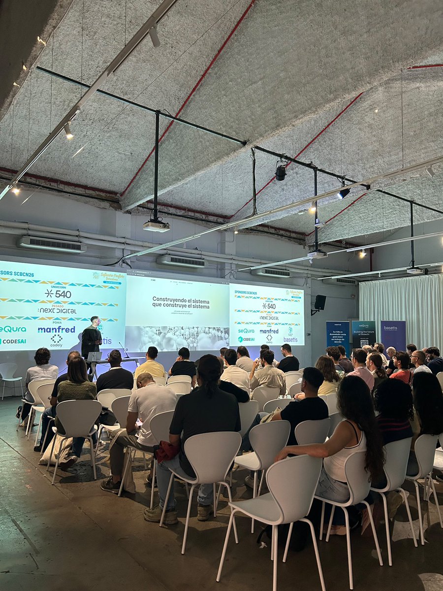 540deg's tweet photo. “Construyendo el sistema que construye el sistema”, @mikelros_ contando en la #scbcn26 cómo hemos construido una software factory que crea software casi sola. Y ese “casi” es muy importante. https://t.co/OL2FfNwHIG