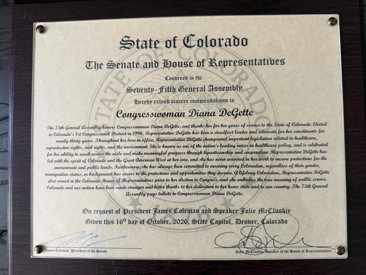 A framed, formal commendation certificate from the State of Colorado, mounted on a dark wooden surface. It honors Congresswoman Diana DeGette and includes a state seal, decorative lettering, signatures, and a date.