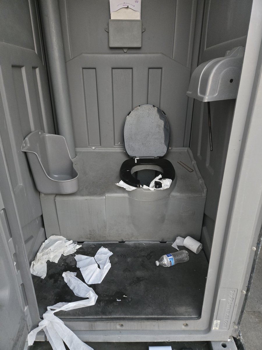 qui_est_J_Galt's tweet photo. DRISCOLL'S BERRIES: A BILLION-DOLLAR BRAND WITH AN APPALLING DISREGARD FOR TRUCK DRIVERS.

After nearly 31 hours dealing with Driscoll's Watsonville, California facility, I am stunned by the disorganization, indifference, and disgraceful sanitary conditions truck drivers are expected to tolerate.

My husband and I arrived at 1 PM for a 5 PM appointment. At 8 PM, we were finally told they didn't have the product. We were instructed to return at 2 PM the following day.

We did. Five more hours of waiting before getting a dock door at 7 PM. Finally loaded at 8 PM. Twenty-seven hours after our original appointment. 27. Hours.

And the bathrooms? Revolting.

Drivers are denied access to flush toilets and relegated to filthy, foul-smelling portable toilets with urine-sticky floors and toilet paper scattered everywhere. There wasn't even toilet paper until I personally went to shipping and requested it.

Flush toilets and running water are right there, behind an "Employees Only" door. If Driscoll's is concerned about keeping those facilities clean, hire someone to maintain them instead of denying drivers basic sanitation.

The handwashing station had NO WATER. Not even the most basic means of washing your hands after using the toilet.

Ironically, Driscoll's still has signs posted requiring face coverings, although nobody appears to enforce them. Yet providing running water and sanitary restrooms for drivers apparently isn't a priority.

Look at the photographs. The filthy facilities, garbage, and tape-covered doors. Is this really the standard at a company as large as Driscoll's?

Truck drivers aren't asking for luxury. We're asking for basic human dignity, sanitation, and professional courtesy.

We keep America's shelves stocked, yet we're treated as though we're disposable.

Driscoll's CEO Brie Reiter Smith, who took over in August, is this what your company considers acceptable treatment of the people hauling your products?

Your berries may be premium, but your treatment of the people hauling them is disgraceful.

Driscoll's should be ashamed.