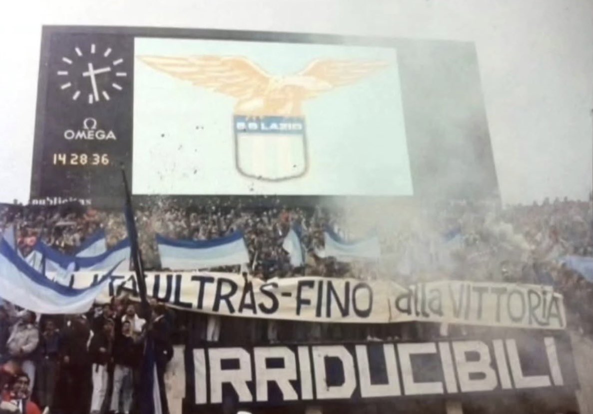 BrigataLazio's tweet photo. 18 ottobre 1987 – 18 ottobre 2026.

39 anni fa, durante Lazio-Padova, veniva esposto per la prima volta uno striscione destinato a entrare nella storia: IRRIDUCIBILI.

Nasceva così un gruppo che avrebbe segnato per sempre la Curva Nord e il panorama ultras italiano.

Dall’esordio all’Olimpico allo storico corteo di San Benedetto del Tronto. Due fotografie, un pezzo di Storia del nostro Popolo.

Tanti auguri, IRRIDUCIBILI!

SE, SE, SEMPRE!
O, OVUNQUE!