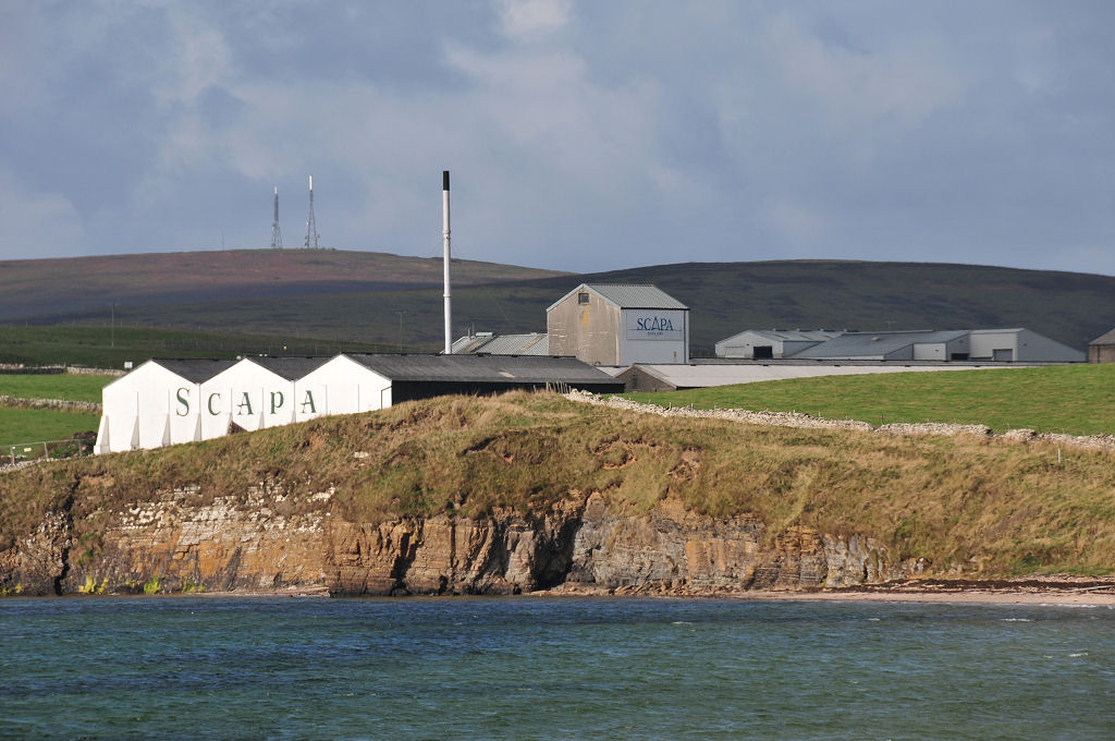 UndisScot's tweet photo. Scapa Distillery, overlooking Scapa Bay not far south of Kirkwall in Orkney. A great distillery to visit, and it comes complete with its name painted in large letters, Islay-esque style, on a sea-facing warehouse wall. #Scotch #whisky More pics and info: https://t.co/JRwySJG1xJ https://t.co/BptzZP7Zwm