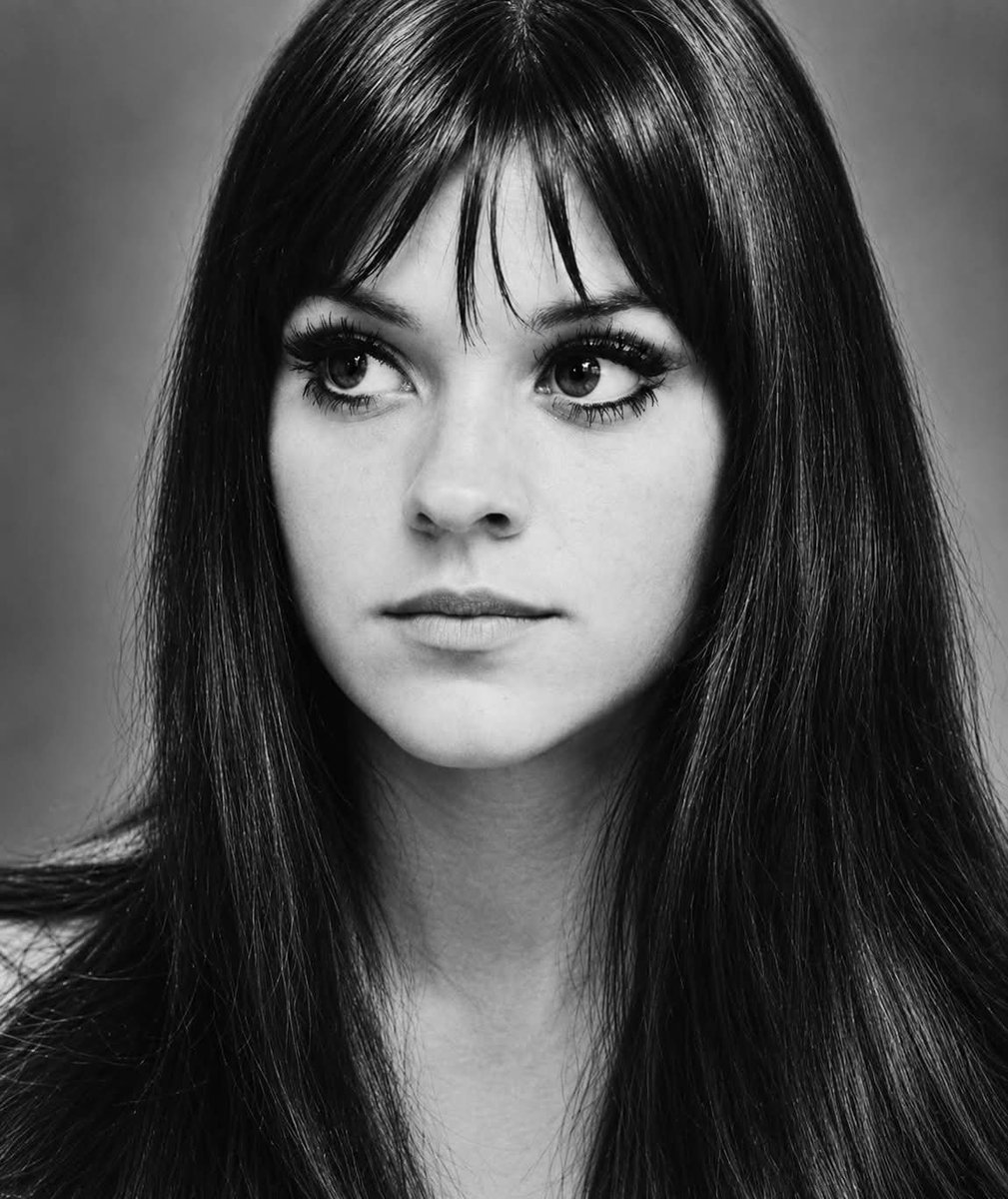 DOGEQEEN's tweet photo. In August 1969, twenty-two-year-old Melanie Safka sat in her mother’s car on the way to what she thought was a small festival. Then she saw a helicopter and a hillside covered in people. She had arrived at Woodstock.

Melanie wasn’t even scheduled to perform. Her label had sent her with no guaranteed place on the bill. Backstage she waited alone in a small tent. Her nerves became so intense that she developed a violent cough and feared she might not be able to sing. Joan Baez noticed and sent over tea and honey.

When rain hit the stage and another act refused to play, the organizers turned to the unknown young woman in the tent. Melanie walked out alone with her guitar. No band, no backup. She sat on a metal folding chair and began to sing. Members of the Hog Farm had been handing out candles. As she performed, first a few flames appeared, then hundreds, then thousands. The muddy hillside filled with light.

The sight stayed with her. She wrote “Lay Down (Candles in the Rain).” It became a Top Ten hit and helped start a tradition that later became phone lights at concerts. The industry still didn’t know where to put her. Too gentle for rock, too independent for the image they wanted. She left Columbia when they tried to reshape her and resisted being packaged as the “cute hippie girl.”

In 1971 she and her husband founded Neighborhood Records, making her one of the first women to own an independent rock label. Her first release on her own terms was “Brand New Key.” It reached number one and sold more than three million copies. She continued recording for decades, released more than thirty albums, remained popular in Europe, and performed into her seventies.

Melanie Safka died on January 23, 2024, at seventy-six, still working on her thirty-second album. After her death her children asked fans to light a candle in her memory. On that night in 1969 she had been a frightened twenty-two-year-old with no guaranteed slot and a cough that threatened her voice. She walked out anyway. People have been holding up their lights ever since.