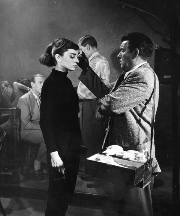 TheFilmLedgermo's tweet photo. Makeup artist Wally Westmore applies mascara to Audrey Hepburn on the set of 'FUNNY FACE' (1957). He was known to separate her lashes with a sewing pin for a sharper look on camera. Hepburn and Fred Astaire filmed in Paris, including at the Eiffel Tower for the musical's 'Bonjour Paris' sequence.