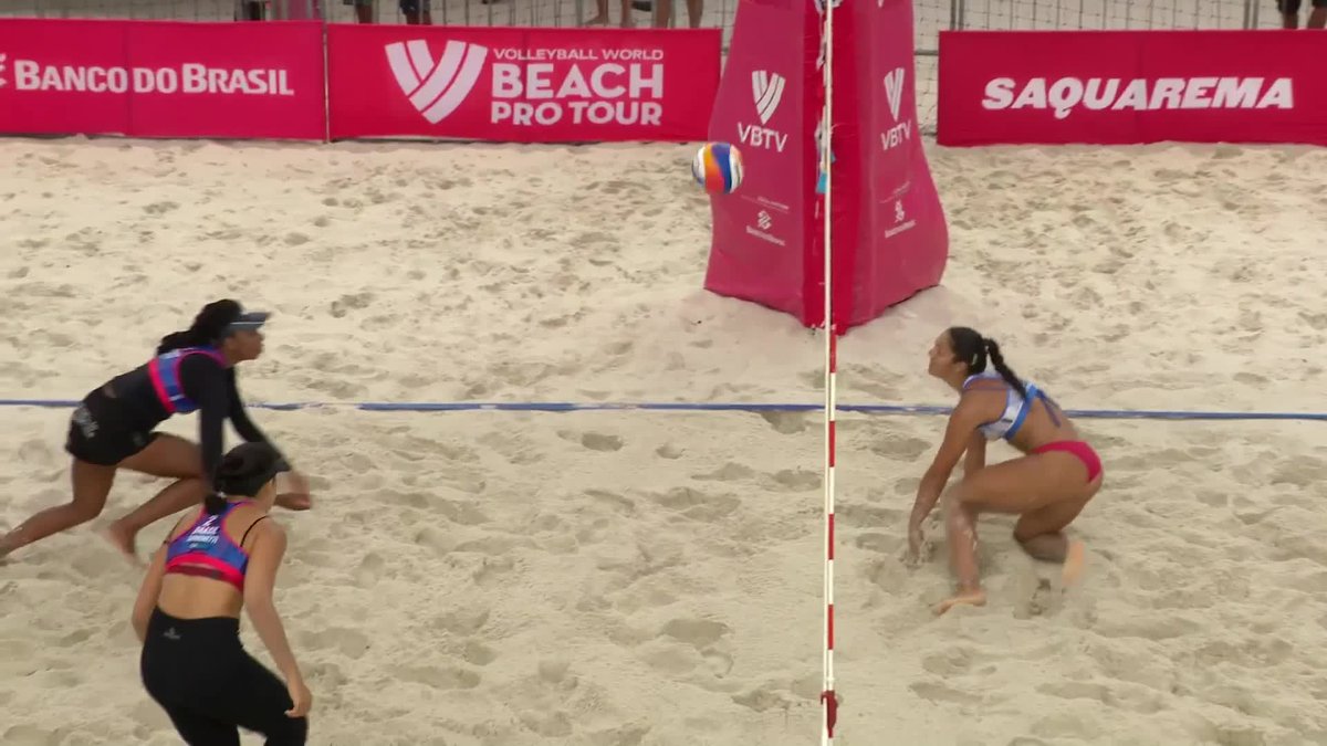 A beach volleyball match at the Volleyball World Beach Pro Tour in Saquarema, sponsored by Banco do Brasil, showing players from both sides of the net on the sand court.