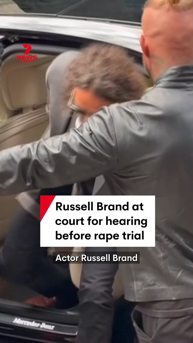 Russell Brand, his face blurred for privacy, exits a Mercedes-Benz vehicle wearing a black leather jacket as he arrives at a London court for a pre-trial hearing on rape and sexual assault charges. The image, branded with the "7 News Australia" logo, accompanies coverage of the 51-year-old actor's appearance, where he has pleaded not guilty to allegations from six women spanning 1999 to 2009.