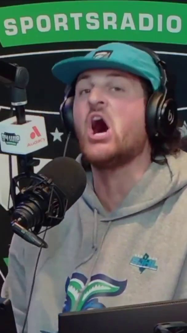 A young man wearing a teal Eagles cap and gray hoodie speaks passionately into a microphone on a "SPORTSRADIO" show, with "94 WIP" and "Audacy" logos visible, illustrating his emotional call for an "Eagles State of Emergency" amid concerns about Jalen Hurts.