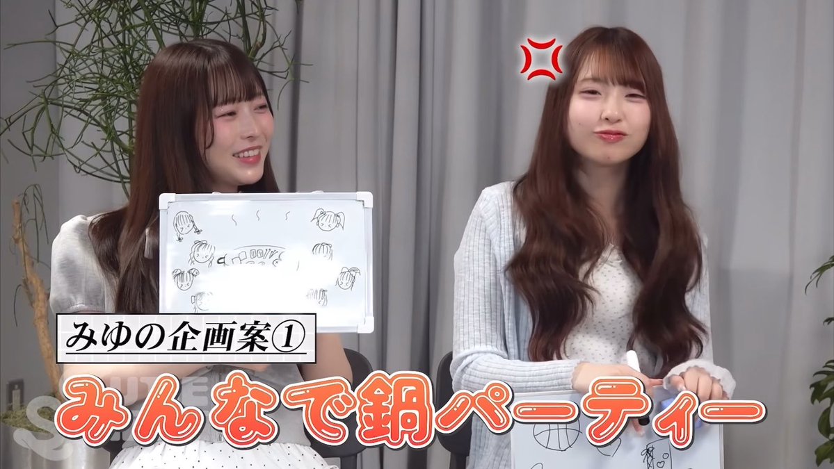 Two young women with wavy brown hair sit together, one holding up a whiteboard with simple doodles, while Japanese text reads "みゆの企画案① みんなで鍋パーティー" (Miyu's Project Plan ①: Let's all have a hot pot party), capturing the playful and chaotic atmosphere referenced in the caption about the lively "kyu-st" group filming.