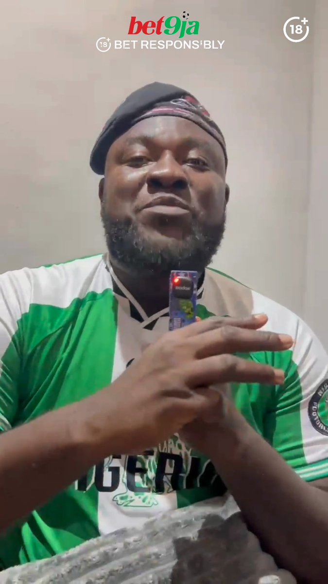 A man wearing a green and white "NIGERIA" jersey and a black cap holds up a small packet toward the camera, with a "bet9ja BET RESPONSIBLY" logo (18+) displayed at the top of the frame, likely sharing his personal reaction to the Super Eagles' recent international window performance.
