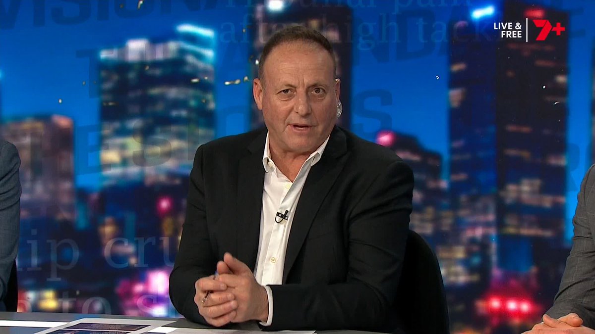A man in a black suit jacket and white shirt sits at a news desk during a live broadcast on the "LIVE & FREE 7+" network, with a cityscape backdrop. The scene corresponds to the post's clip of Liam Pickering confidently confirming that Gryan Miers will remain at Geelong next year.