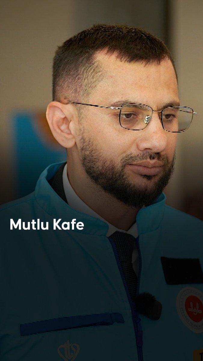 A man with a beard, glasses, and short hair wears a teal uniform jacket with a logo patch, looking downward, with the name 'Mutlu Kafe' displayed in white text on the left.