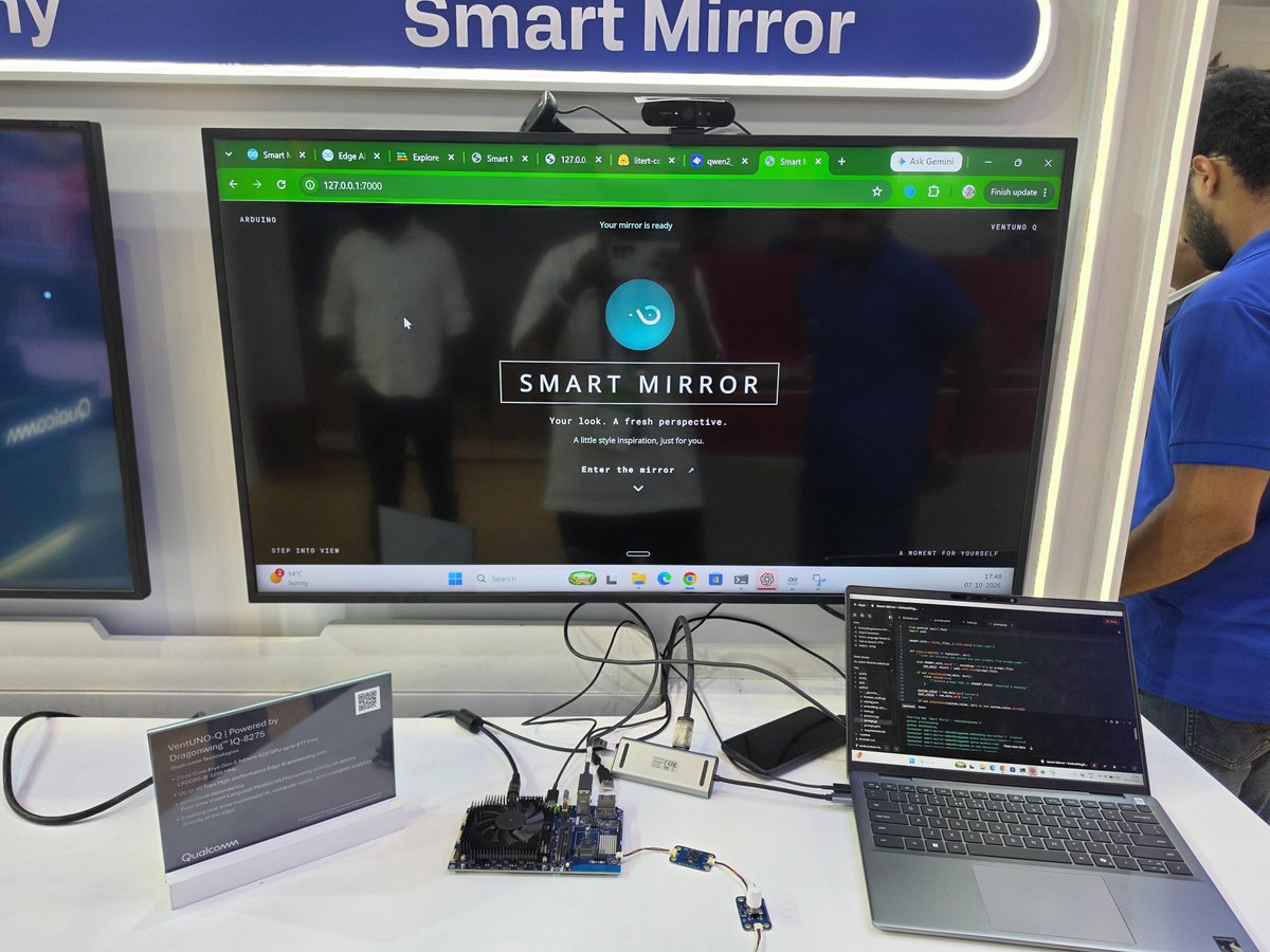 HowDevelop's tweet photo. Power of Local AI 😍 Running a custom Smart Mirror Demo application with @arduino Ventuno Q powered by a @Alibaba_Qwen 2.5 VL 7B model to describe what you wear, @googlegemma EmbeddingGemma 2 model for multi-modal vector search to find similar dresses, PiperTTS all targeting the @Qualcomm_Dev NPU on the Ventuno Q at IMC 2026. 

Stand in front of the mirror - and get recommendations on how to improve your outfit and get recommendations on other clothing options you can try all offline.