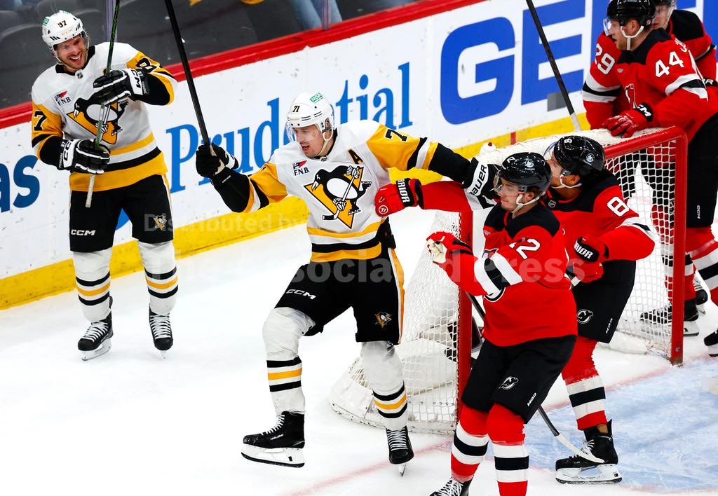 sidgeno88's tweet photo. sidney crosby delighted by evgeni malkin casually punching a devil in the head https://t.co/hdxhuEmGe2