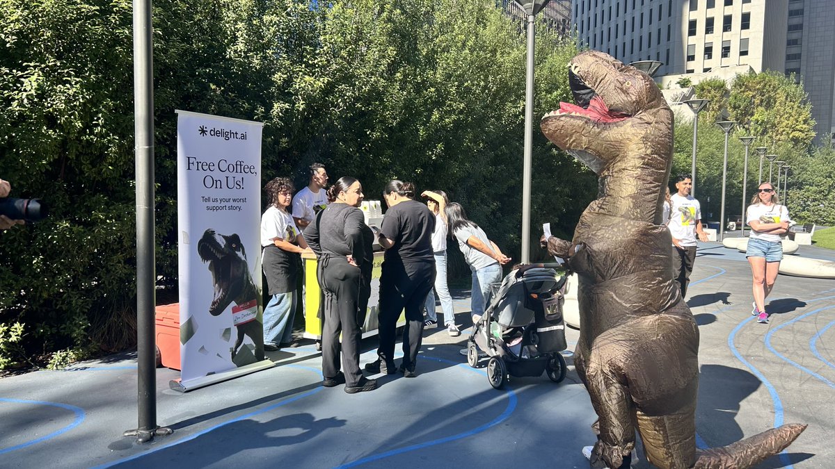 GetDelightAI's tweet photo. There's a dinosaur handing out free coffee at 200 Howard St right now. ☕ 🦖 

His name is Zen Deskosaur. He's been on hold for 66 million years, so he knows a thing or two about bad support.

We're at Urban Park until 2pm for #SFTechWeek. High fives are also free.

#SFTechWeek #CustomerExperience #CX
