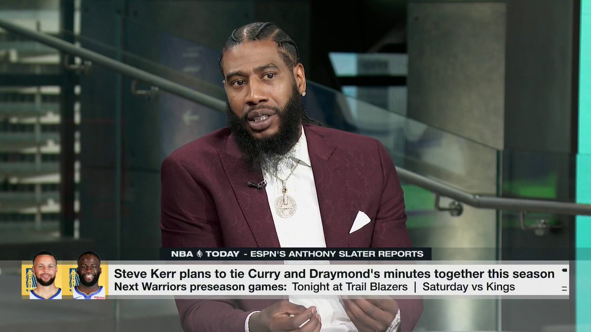Former NBA player Iman Shumpert, dressed in a burgundy suit with a large pendant chain, appears on ESPN's NBA Today discussing how having Stephen Curry and Draymond Green on the floor together made the Golden State Warriors dangerous, as noted in the on-screen graphic reporting Steve Kerr's plan to tie their minutes together this season.