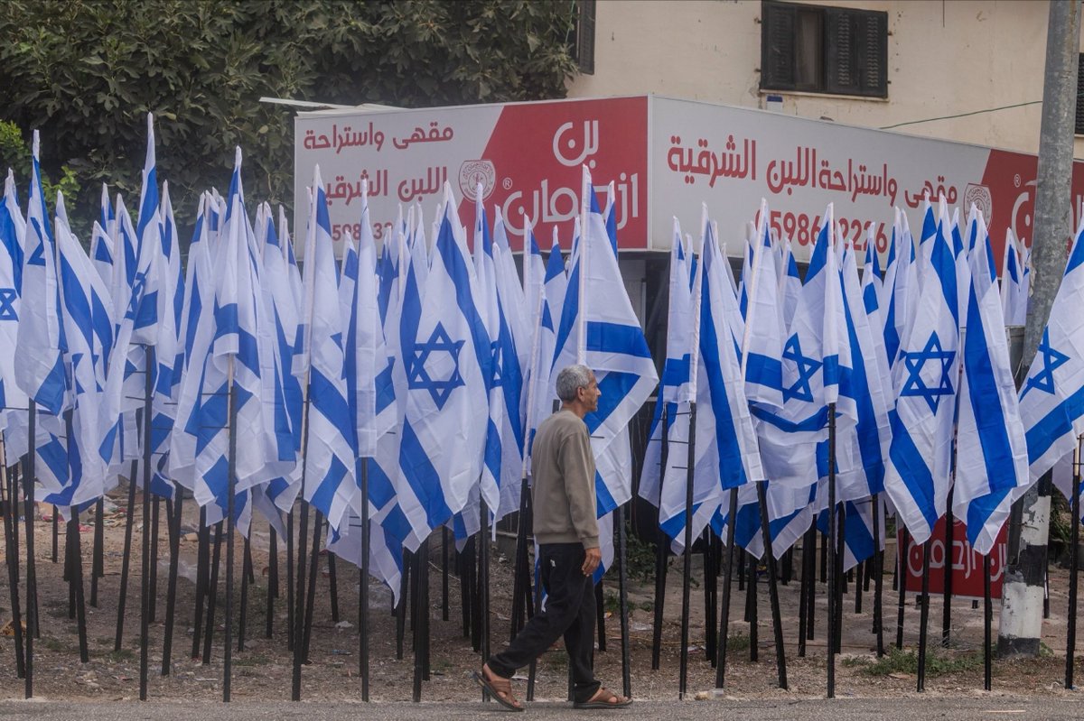 EyeonPalestine's tweet photo. Israeli settlers installed hundreds of Israeli flags in front of Palestinian resident Mou’ayyad Mahmoud’s shop in Al-Lubban Al-Sharqiya, near Nablus, blocking access to his business. Mahmoud says Israeli police told him not to remove the flags after he reported the obstruction.

مستوطنون ينصبون مئات الأعلام أمام متجر المواطن مؤيد محمود في قرية اللبن الشرقية قرب نابلس، ما أعاق الوصول إلى متجره. ويقول محمود إن الشرطة الإسرائيلية طلبت منه عدم إزالة الأعلام بعد إبلاغها عن عرقلة الوصول إلى محله.
