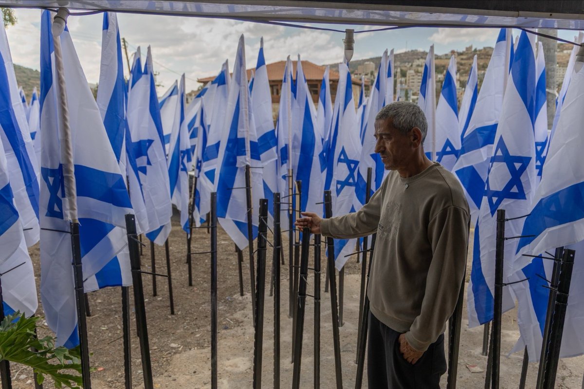 EyeonPalestine's tweet photo. Israeli settlers installed hundreds of Israeli flags in front of Palestinian resident Mou’ayyad Mahmoud’s shop in Al-Lubban Al-Sharqiya, near Nablus, blocking access to his business. Mahmoud says Israeli police told him not to remove the flags after he reported the obstruction.

مستوطنون ينصبون مئات الأعلام أمام متجر المواطن مؤيد محمود في قرية اللبن الشرقية قرب نابلس، ما أعاق الوصول إلى متجره. ويقول محمود إن الشرطة الإسرائيلية طلبت منه عدم إزالة الأعلام بعد إبلاغها عن عرقلة الوصول إلى محله.