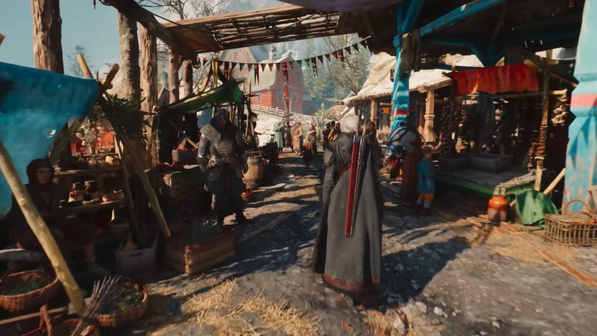A hooded figure with a sword on their back walks through a bustling medieval-style market filled with wooden stalls, villagers, and colorful banners, showcasing the lush open-world environment of The Witcher 4. The scene reflects the game's richly detailed fantasy setting referenced in the post.