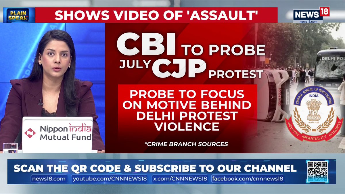 A news anchor on CNN-News18's "Plain Speak" segment reports on a CBI probe into a July protest by Congress leader Rahul Gandhi, with on-screen text stating "CBI TO PROBE JULY CJP PROTEST" and "PROBE TO FOCUS ON MOTIVE BEHIND DELHI PROTEST VIOLENCE." The broadcast covers BJP's allegations that Gandhi pushed a woman cop during the demonstration.