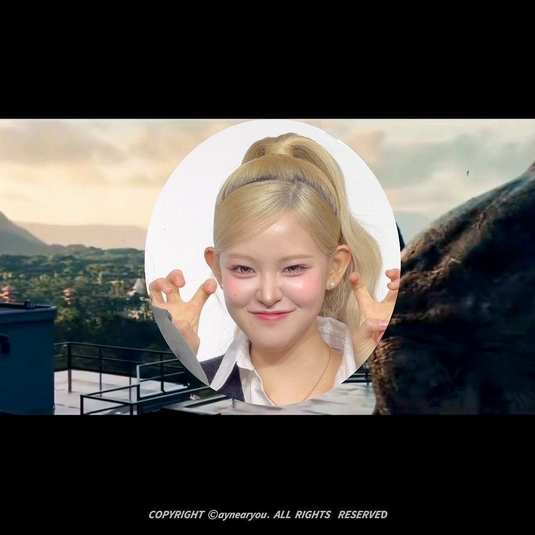 An edit showing a cutout of a blonde K-pop idol (appears to be from Blackpink's Jennie) making a cute gesture with her hands, overlaid on a landscape scene, with text 'COPYRIGHT ©aynearyou. ALL RIGHTS RESERVED'.