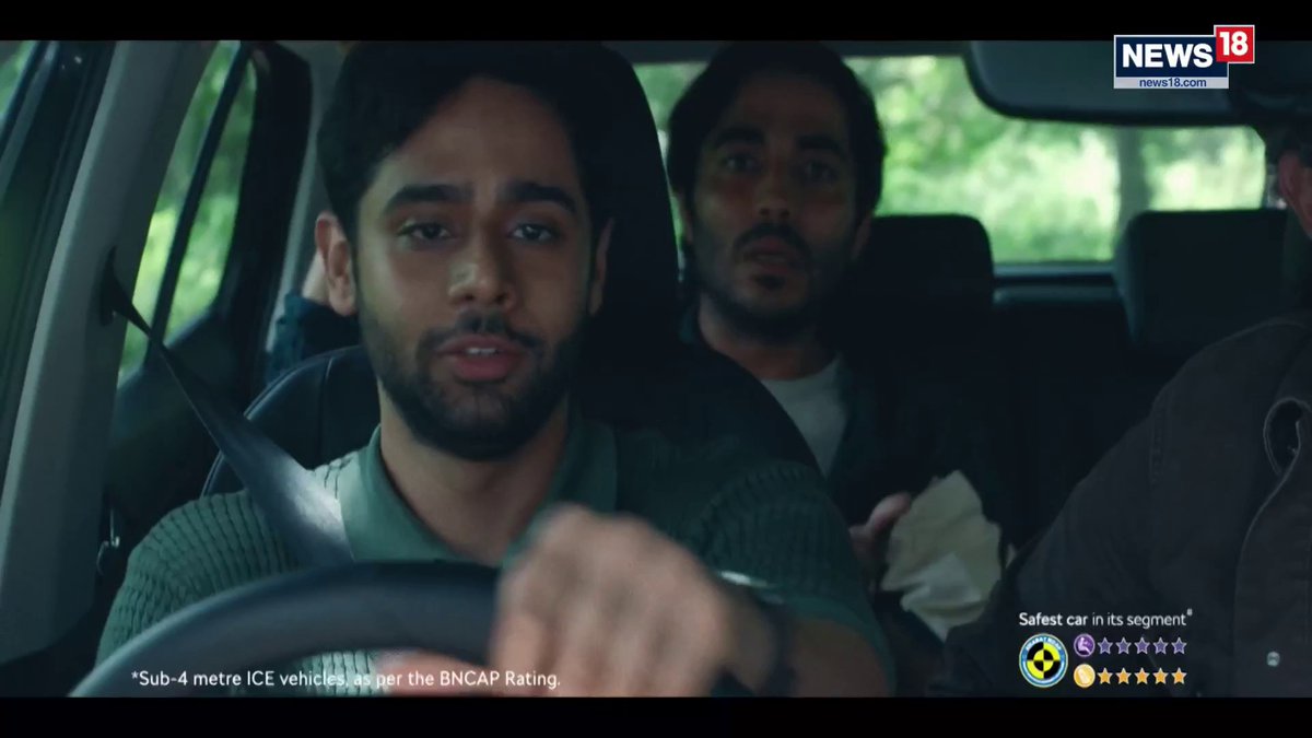 A young man drives a car with passengers in the back seat, with the "News18" logo visible in the top right corner. Text on screen reads "*Sub-4 metre ICE vehicles as per the BNCAP Rating" alongside safety ratings of "Safest car in its segment" featuring 5-star ratings for adult and child occupant protection, shown in what appears to be a Hyundai car advertisement.
