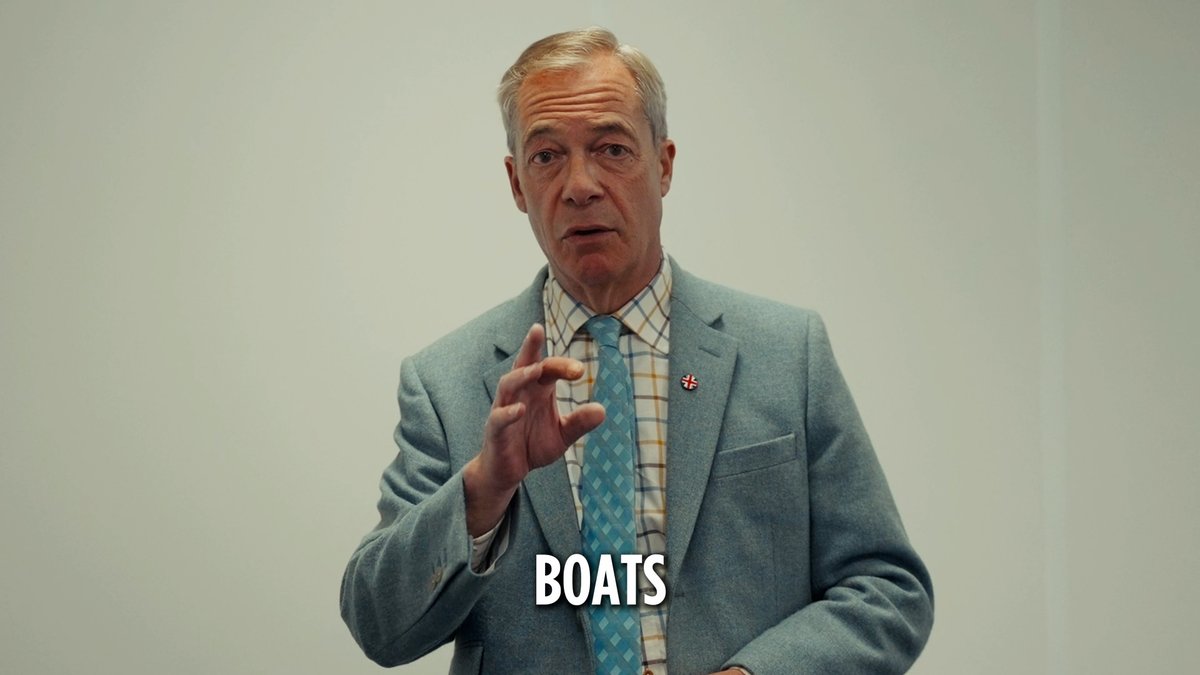 Nigel Farage, wearing a blue checkered tie and grey blazer with a small pin, gestures while speaking as the caption "BOATS" appears below him. The image accompanies his comments framing illegal Channel crossings as a "national security emergency," with the "BOATS" label visually emphasizing the topic of small boat migrant arrivals in Britain.