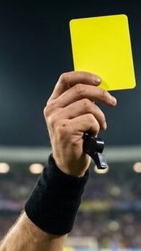A referee's hand, wearing a black wristband, holds up a yellow penalty card against a stadium backdrop, symbolizing a disciplinary action. The image visually reinforces the post's request for others to share their own "top 5" lists, as the yellow card serves as a metaphor for calling out or penalizing choices.