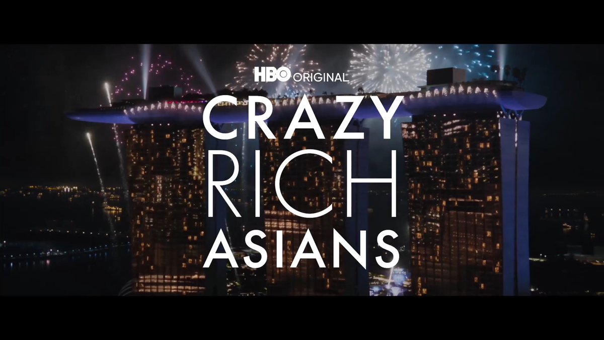 A nighttime aerial view of Singapore’s Marina Bay Sands shows fireworks bursting above the rooftop and illuminated towers. Centered over the scene is white text reading “HBO ORIGINAL” and, in large stacked capital letters, “CRAZY RICH ASIANS,” matching the post’s teaser for the HBO Max sequel series.