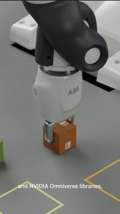 A 3D-rendered close-up shows an ABB robotic gripper holding a small brown box above a gray tabletop marked with yellow and green outlines. The ABB logo is visible on the robot wrist, and a lower subtitle reads, “and NVIDIA Omniverse libraries,” matching the post’s description of using NVIDIA Omniverse tools and skills to prepare ABB’s YuMi robot as a SimReady asset in Isaac Sim.