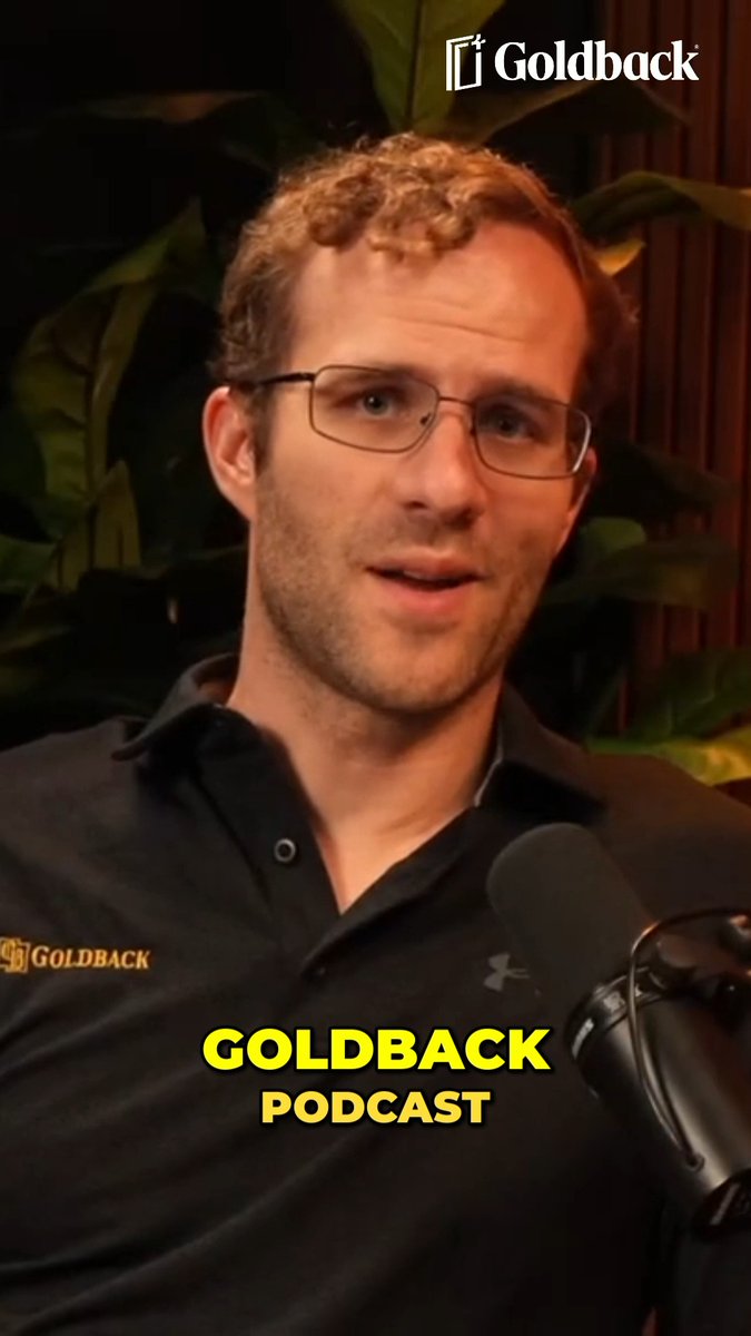 A man with glasses and a black polo shirt speaks into a Goldback Podcast microphone, with the 'Goldback' logo in the upper right and 'GOLDBACK PODCAST' in yellow text at the bottom.