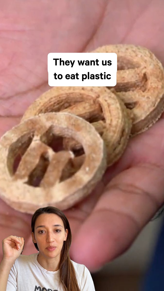 A woman gestures in the foreground while holding up three plastic microplastic pellets in her hand, with text overlay reading "They want us to eat plastic," highlighting concerns about microplastic pollution and tying into the post's message about holding polluters accountable rather than focusing on small consumer changes like plastic straws.
