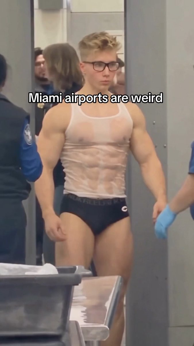 The image shows a young man wearing only a white tank top, briefs, glasses, and blue gloves going through airport security, with overlaid text reading "Miami airports are weird." The caption "Why they do this everytime haha?" humorously refers to the TSA screening process, where travelers at Miami airports are sometimes required to step out of their clothes into more revealing attire for additional pat-downs.
