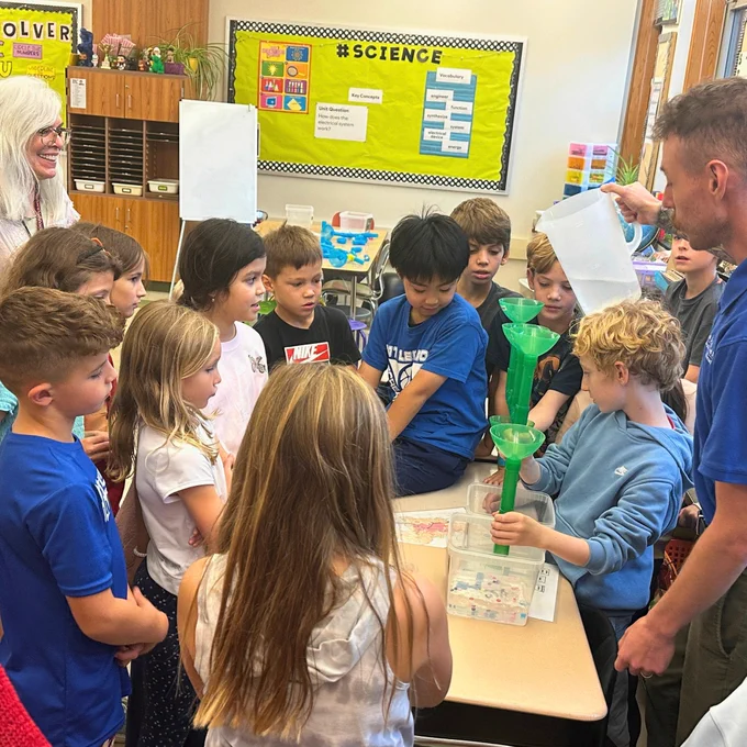 4th grade students complete a hands on science project in the classroom