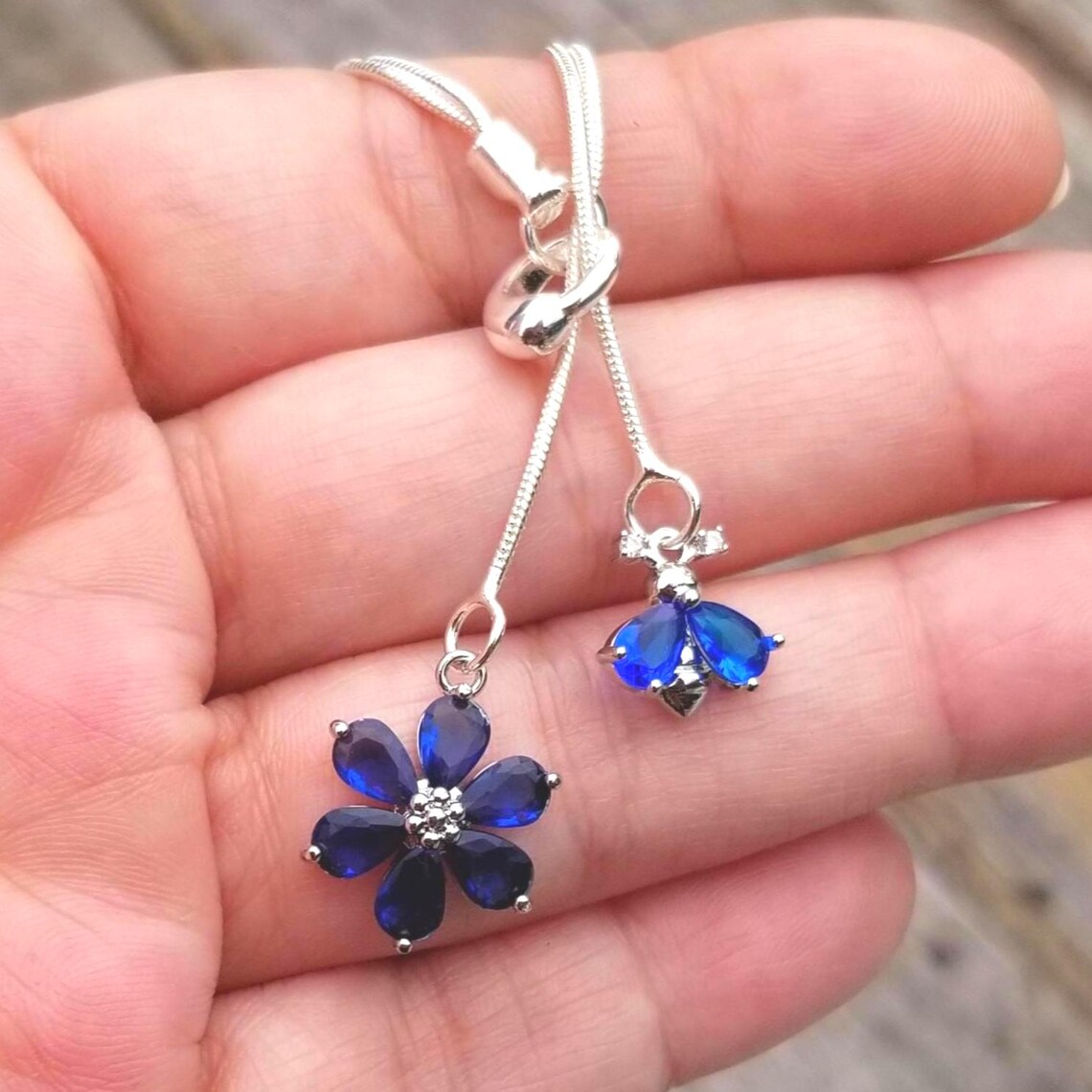 TrendingNowGift's tweet photo. Double Strand Sterling Silver Sapphire Lariat Necklace #jewelry #necklace #lariat #silvernecklace #bee #bumblebee #flower #sapphire #sapphirejewelry #sapphirenecklace #handmadejewelry #ChristmasGiftIdeas #gift #gifts #Giftsforher 
 https://t.co/uilxcPe0z3 via @Etsy https://t.co/LrIaxFpBNJ