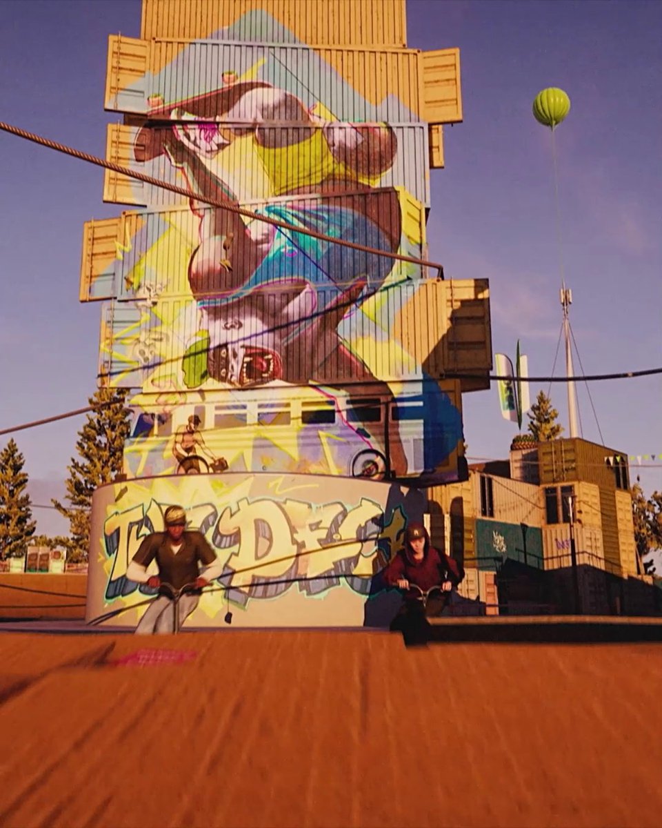 A vibrant urban scene featuring two BMX riders in front of a towering stack of shipping containers covered in colorful graffiti, including the word 'TROPIC' and an animated figure.