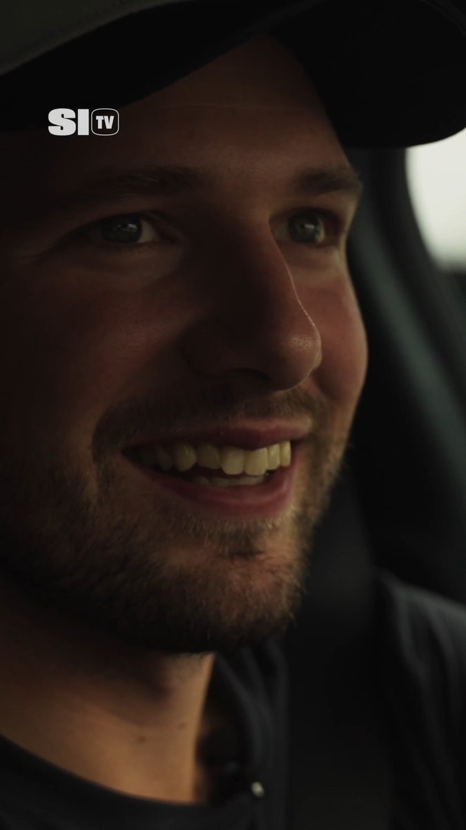 A close-up selfie shows Luka Dončić smiling inside a car, wearing a dark cap and dark shirt. A white “SI TV” logo appears in the top-left corner, and the accompanying post says he reveals his go-to karaoke song.