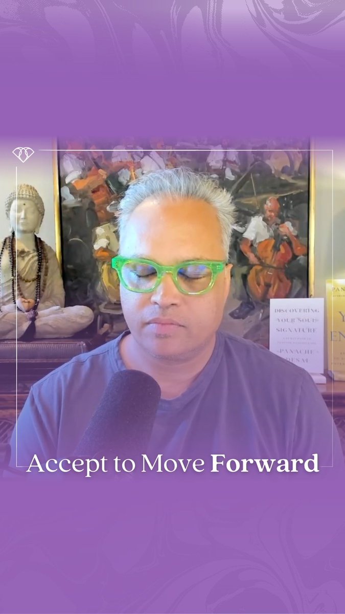 A man with grey hair and bright green glasses sits with closed eyes in front of a microphone, with the text 'Accept to Move Forward' displayed below. Behind him are a Buddha statue, artwork, and books including 'Discovering Your Soul Signature' and 'Panache Desai'.