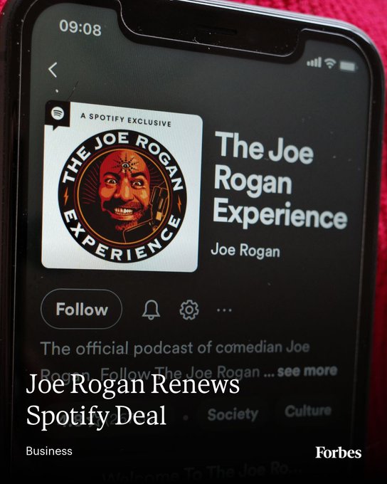 A smartphone displays the Spotify page for "The Joe Rogan Experience" podcast, marked as "A Spotify Exclusive," with a Forbes article headline reading "Joe Rogan Renews Spotify Deal," illustrating the multi-year licensing agreement between the comedian and the streaming platform.