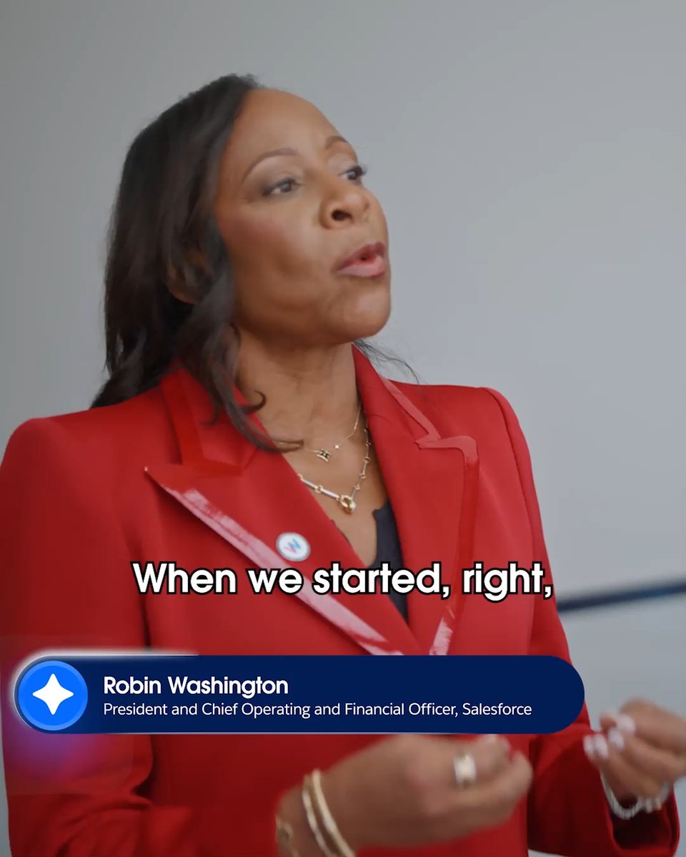 Robin Washington, identified as President and Chief Operating and Financial Officer of Salesforce, speaks while wearing a red blazer, with subtitles reading 'When we started, right,'.