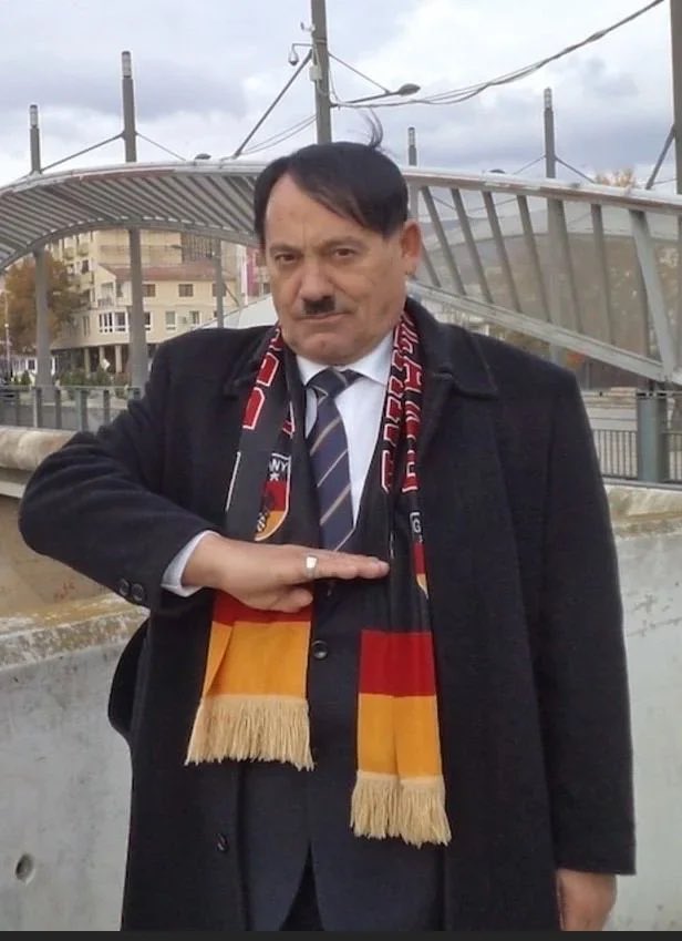 souljagoyteller's tweet photo. Learning about Emin Xhinovci, a Kosovar former restaurant owner who now works full-time as a “Hitler for Hire”, running a Hitler-themed pizzeria, selling Nazi memorabilia, and charging tourists money for photos. He frequently attends funerals &amp; weddings. https://t.co/qzpImPLNiF
